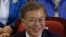 Moon Jae-in of the Democratic Party smiles as and leaders and members of the party watch local broadcast media's results of exit polls in the presidential election in Seoul, South Korea, May 9, 2017.