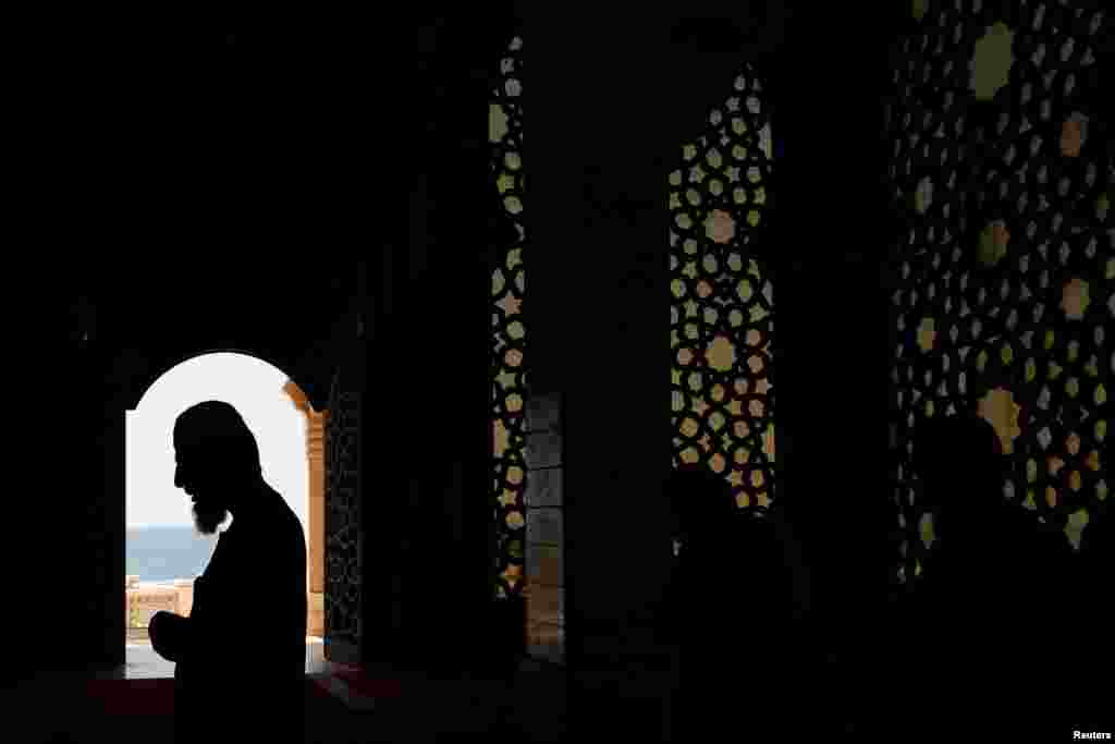 Palestinian members pray in an almost empty mosque as Friday prayers in the holy places are suspended following an outbreak of the coronavirus disease in the northern Gaza Strip.