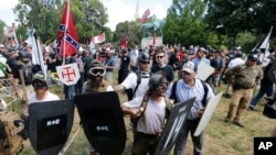 "Alt-right" demonstrators clash with counter-demonstrators at the entrance to Lee Park in Charlottesville, Va., Aug. 12, 2017.