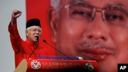 FILE - Malaysian Prime Minister Najib Razak addresses delegates during his speech at the Malaysia's ruling party United Malays National Organization's (UMNO) anniversary celebration.