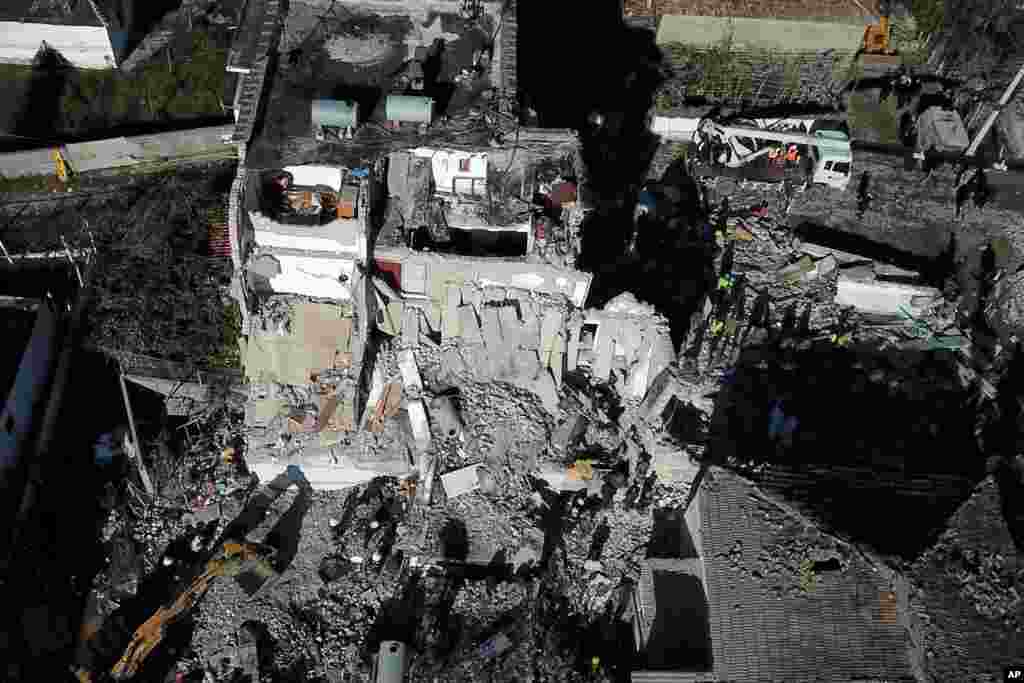 Rescuers conduct a search at a damaged building after a magnitude 6.4 earthquake in Thumane, western Albania. The powerful pre-dawn earthquake killed at least 18 people and injured more than 600.