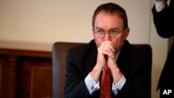 FILE - In this Jan. 2, 2019, file photo White House chief of staff Mick Mulvaney listens as President Donald Trump speaks during a Cabinet meeting at the White House in Washington.