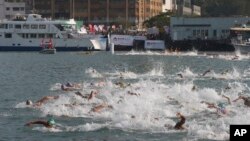 FILE - Competitors swim during the annual 1.5-kilometer (0.93-mile) harbor race at the Victoria Harbor in Hong Kong, Oct. 18, 2015.