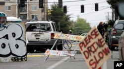 A car with broken windows and bullet holes that was involved in a shooting sits in the street in Seattle, where streets are blocked off in what has been named the Capitol Hill Occupied Protest zone, June 29, 2020.
