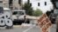 A car with broken windows and bullet holes that was involved in a shooting sits in the street in Seattle, where streets are blocked off in what has been named the Capitol Hill Occupied Protest zone, June 29, 2020.