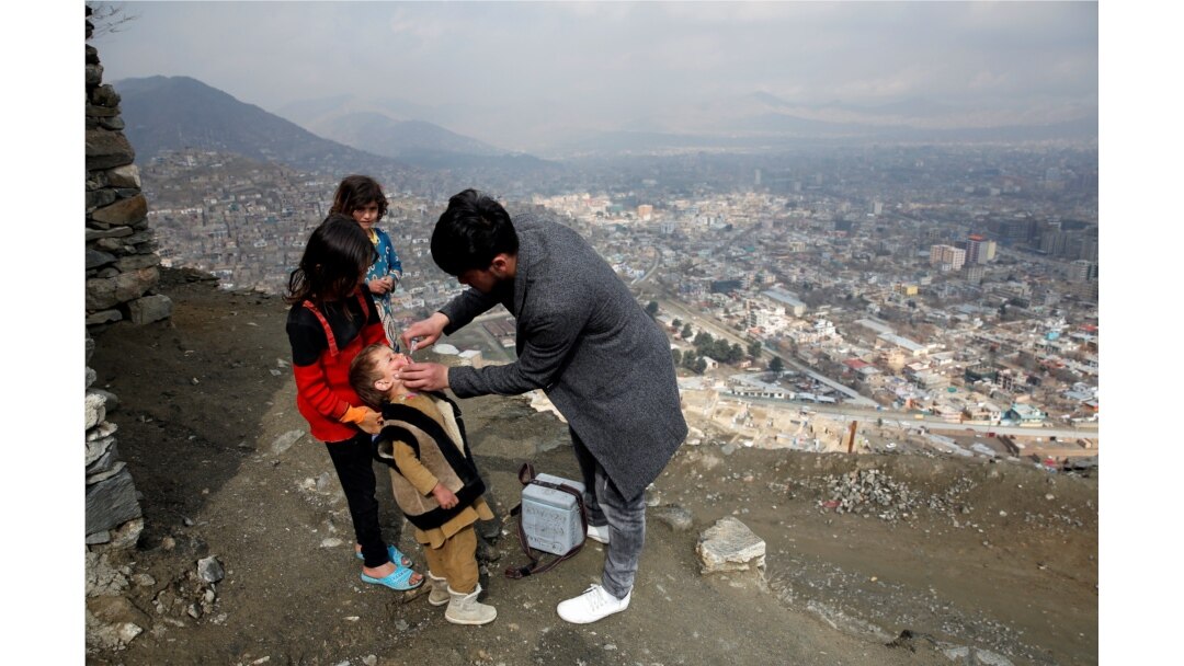 FILE - A boy receives polio vaccination drops during an anti-polio campaign in Kabul, Afghanistan, March 14, 2018.