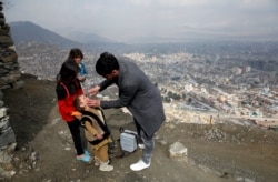 FILE - A boy receives polio vaccination drops during an anti-polio campaign in Kabul, Afghanistan, March 14, 2018.