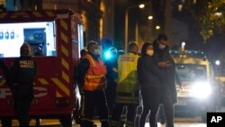 Police work at the scene after a Greek Orthodox priest was shot Oct.31, 2020, while he was closing his church in Lyon, France. 