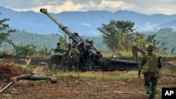 FILE - Members of an ethnic armed forces group, one of the three militias known as the Three Brotherhood Alliance, check weapons the group said it seized from Myanmar's army outpost in Hsenwi, Myanmar, on Nov. 24, 2023. (Kokang online media via AP)