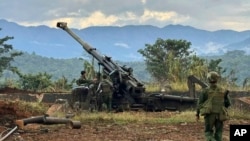 Members of an ethnic armed forces group, one of the three militias known as the Three Brotherhood Alliance, check weapons the group said it seized from Myanmar's army outpost in Hsenwi, Nov. 24, 2023. (Kokang online media via AP)