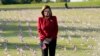 House Speaker Nancy Pelosi looks at small flags placed on the grounds of the National Mall by activists from the COVID Memorial Project to mark the deaths of 200,000 lives lost in the U.S. to COVID-19, in Washington, D.C.