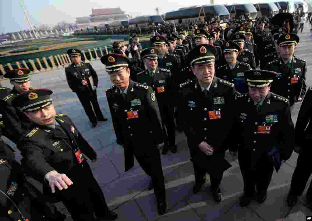 Delegates from Chinese People's Liberation Army line up on Tiananmen Square as they prepare to walk toward the Great Hall of the People for the opening session of the National People's Congress, March 5, 2013.