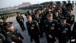 FILE - Delegates from Chinese People's Liberation Army line up on Tiananmen Square as they prepare to walk toward the Great Hall of the People for the opening session of the National People's Congress, March 5, 2013.