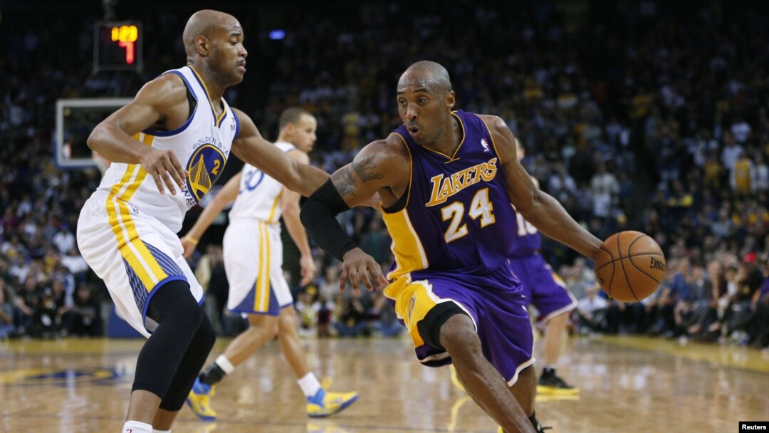 Pemain Los Angeles Lakers Kobe Bryant (kanan) menggiring bola basket, dijaga oleh Jarrett Jack dari Golden State Warriors pada pertandingan NBA Desember 2012. (Reuters/Stephen Lam)