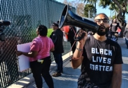 Protesters with Black Lives Matter protest a visit by Democratic presidential candidate and former South Bend, Ind., Mayor Pete Buttigieg, during a visit to A Bridge Home Project homeless shelter in Los Angeles, Jan. 10, 2020.