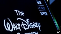 FILE - A screen shows the logo and a ticker symbol for The Walt Disney Company on the floor of the New York Stock Exchange in New York, Dec. 14, 2017.