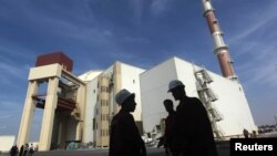FILE - Iranian workers stand in front of the Bushehr nuclear power plant, about 1,200 km (746 miles) south of Tehran.