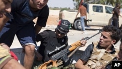 Libyan rebels are seen in the back of a pick-up truck headed for the frontline near Zawiya in western Libya, August 13, 2011