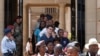 Members of the public make their way through the Union Buildings to pay their respects to former South African President Nelson Mandela during his lying in state in Pretoria, South Africa, Wednesday, Dec. 11, 2013.