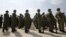 FILE - Soldiers of Japan's Self Defence Force stand at attention during the opening ceremony of a military base on the island of Yonaguni in the Okinawa prefecture, March 28, 2016. 