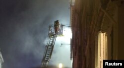 A firefighter works after a building collapsed in Marseille