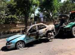 A damaged car is towed away from the site of an explosion in Kabul, Afghanistan, Friday, July 19, 2019. A powerful bomb exploded outside the gates of Kabul University in the Afghan capital on Friday, according to police and health officials. (AP…