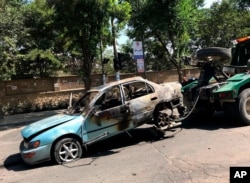 A damaged car is towed away from the site of an explosion in Kabul, Afghanistan, Friday, July 19, 2019. A powerful bomb exploded outside the gates of Kabul University in the Afghan capital on Friday, according to police and health officials. (AP…