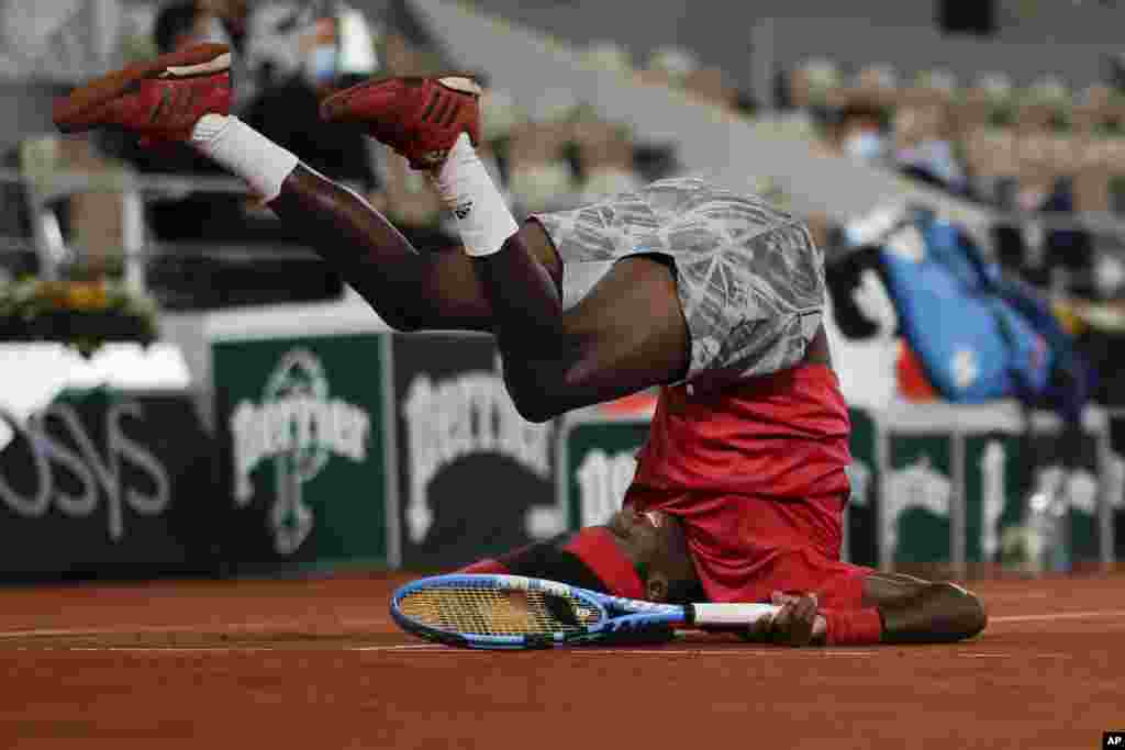 Mikael Ymer of Sweden slips and falls in the first round match of the French Open tennis tournament against Serbia&#39;s Novak Djokovic at the Roland Garros stadium in Paris, France.