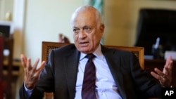 The Arab League's Secretary-General Nabil Elaraby speaks to Nasr al-Hariri, secretary-general of the Syrian National Coalition, Syria's main opposition group, at the League's headquarters in Cairo, Egypt, Sept. 6, 2014. 