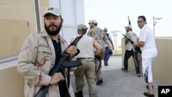 Libyan rebels patrol to try to find any of Moammar Gadhafi's relatives in Tripoli, Libya, August 24, 2011