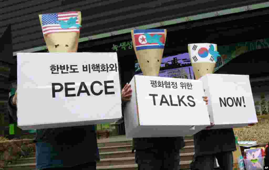 South Korean protesters wearing envelopes participate in a rally to mark Global Day of Action on Military Spending near the U.S. embassy in Seoul, April 15, 2013.