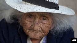 Julia Flores Colque, 117 years old, sits outside her home in Sacaba, Bolivia, Aug. 23, 2018. At 117 and just over 10 months, she would be the oldest woman in Bolivia and perhaps the oldest living person in the world. (AP Photo/Juan Karita)