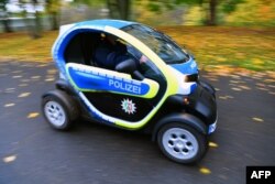 A police car run on electric energy drives along a street at the "Bonn Zone" on Nov. 8, 2017, during the COP23 U.N. Climate Change Conference in Bonn, Germany.