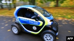 A police car run on electric energy drives along a street at the "Bonn Zone" on Nov. 8, 2017, during the COP23 U.N. Climate Change Conference in Bonn, Germany. 