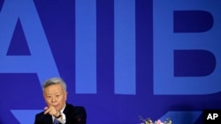 FILE - Jin Liqun, inaugural president of the Asian Infrastructure Investment Bank (AIIB), gestures as he speaks during a press conference at a hotel in Beijing, Jan. 17, 2016. 