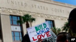 People protest immigration separation policies outside the federal court in El Paso, Texas, June 26, 2018.