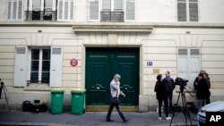 A Tuesday, Oct. 3, 2017 file photo showing the entrance of an apartment building where police found an explosive device. Three men have been handed preliminary terror-linked charges in the failed attack at a residential building in an upscale Paris neighborhood with gas canisters that failed to ignite. A judicial official said on Saturday, Oct. 7, 2017 that the three were placed under formal investigation late Friday in the mysterious attack attempt.