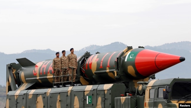 Pakistani military personnel stand beside a Shaheen III surface-to-surface ballistic missile during Pakistan Day military parade in Islamabad, Pakistan, March 23, 2019.