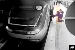 FILE - In surveillance video played by Iranian state television, women pull 16-year-old Armita Geravand out of a train carriage on the Tehran subway in Tehran, Iran, on October 1, 2023.