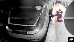 In this image from surveillance video aired by Iranian state television, women pull 16-year-old Armita Geravand from a train car on the Tehran metro, in Tehran, Iran, Oct. 1, 2023.