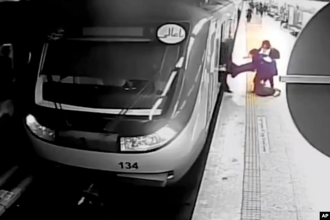 FILE - In this image from surveillance video aired by Iranian state television, women pull 16-year-old Armita Geravand from a train car on the Tehran Metro in Tehran, Iran, on Oct. 1, 2023.