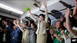 Former defense minister Yuriko Koike, center, celebrates her election as Tokyo governor with supporters.