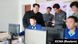 FILE - North Korean leader Kim Jong-un (l) gives field guidance at the Wonsan Shoe Factory in this undated photo released by North Korea's Korean Central News Agency (KCNA) in Pyongyang, Nov. 27, 2015. 