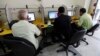 FILE - People surf the Internet at an Internet cafe in Baghdad, Nov. 11, 2012. 