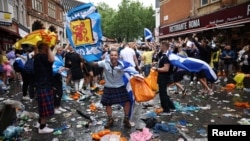 Scotland fans gather in Leicester Square prior to the Euro 2020 soccer championship match between England and Scotland, in London.