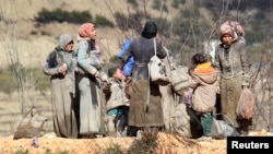 Người Syria thất tán quần áo dính đầy bùn đất chờ đợi tại thị trấn Khirbet Al-Joz để được vào Thổ Nhĩ Kỳ, ngày 7/2/2016. Những người Syria bỏ nhà cửa đi lánh nạn hiện phải chịu đựng giá rét, đói khát và chết chóc trên đường tị nạn.