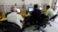 FILE - People surf the Internet at an Internet cafe in Baghdad, Nov. 11, 2012. 