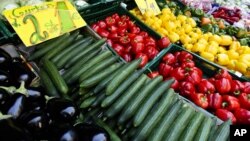 Cucumbers, two for 1 Euro ( $1.40) , are displayed for sale between other vegetables outside a supermarket in Berlin, Germany, May 30, 2011. 