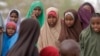 FILE - Children watch as another child is vaccinated in the town of Liboi, Kenya, July 27, 2011. Kenyan authorities on Friday launched a mass vaccination program against the human papilloma virus, or HPV.