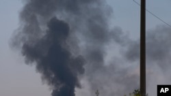 Black smoke rises from a shot down Ukrainian Army helicopter outside Slovyansk, Ukraine, May 29, 2014.